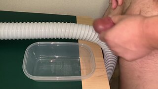 Man of large size urinating and ejaculating into a plastic container