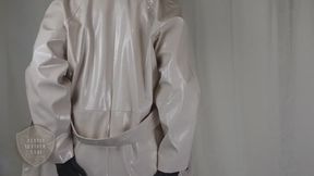 Classy Leather Lady poses in PVC coat, flexes with cane, gives instructions