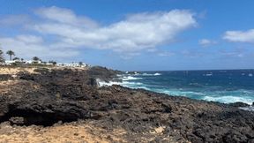 Naked girl naturist walking through the beach to the natural pool