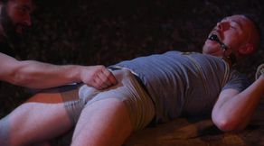 Nude male slave shared in rough kinks by two dominant hunks