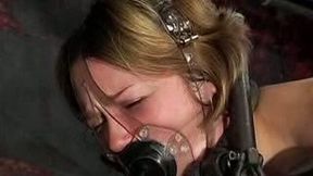 Lusty blonde beauty is suspended and toyed in the darkness