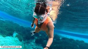 Carissa in the orange dive skin in the spring freediving part 1