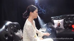 Elegant Asian Woman Blows Thick Smoke Rings While Smoking Cigarette