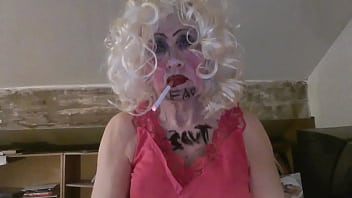 CD Sissy Sarah Millward knows her ID, as indicated by what&#039_s written on her face and chest - &#039_fag slut&#039_ -   as she smokes, wanks her clit, and stuffs a dildo up her nasty lady hole