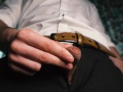Sexy guy in a suit jerks off close-up, moans with pleasure and cums in a condom.