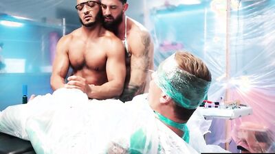 Two muscular hunks restrain a guy to stroke his cock