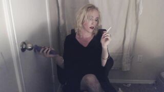 Goth Tranny smokes and pleasures herself.