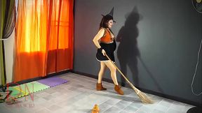 HALLOWEEN 2021 Witch in a sexy red suit. Red-haired witch with pumpkins and a broom. Regina Noir Backstage