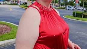 Beautiful woman walking outdoors in public parking lot showing off for strangers
