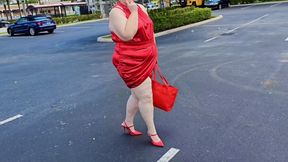 Beautiful woman walking outdoors in public parking lot showing off for strangers