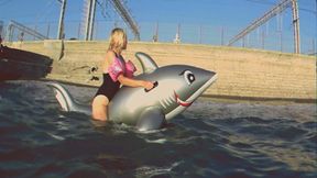 Alla has fun riding a big inflatable gray shark on the sea !!!