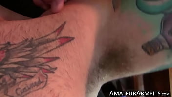 Horny inked stallion sniffs his armpits while masturbating