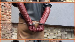 Handcuffed wife in leather and long cinnamon gloves