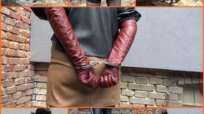 Handcuffed wife in leather and long cinnamon gloves