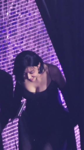 Female performer in a purple dress on stage