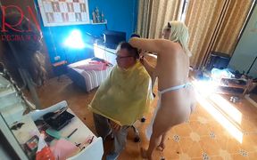 Nudist barbershop. Nude lady hairdresser in an apron, the client is surprised