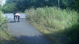 Crossdressed in black stockings in public path by road