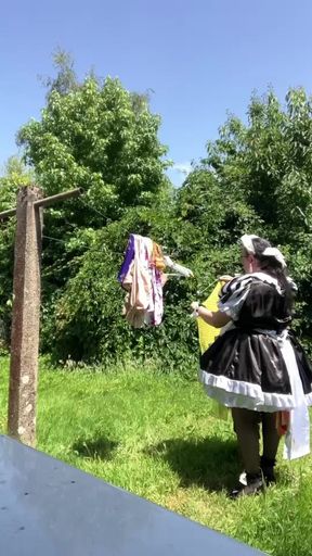 In a black and white maid outfit to hang out the laundry.