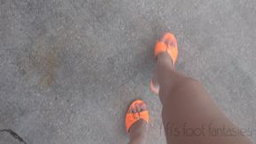 Fifi desperately cranking her old SUV in bright orange high heel stilettos with orange toenail polish while telling cranking stories