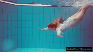 Redhead in a white dress and sexy bikini