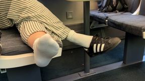 Candid shoeplay in Adidas sneakers on the train