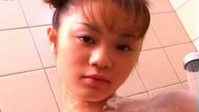 Horny Japanese coed with perky tits lathers her body with soap seductively