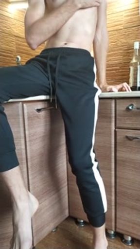 The guy jerks off a dick in the morning and massages the ass in the kitchen