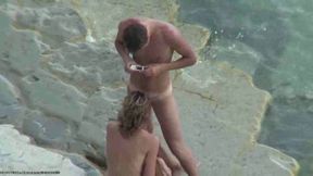 Nude couple caught fucking missionary style on the rocky beach