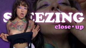 Loud, wet sneezes. Close-up