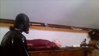 Rubtoy, in latex enjoying a session on the rack