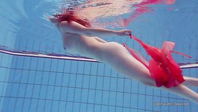 Fire red haired girl Katrin Privsem swimming naked in a pool