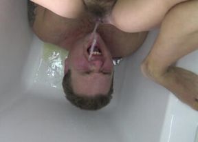 Pissing femdoms rewarding sub in the bathtub with golden shower