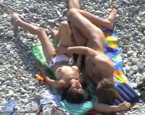 Torrid brunette MILF gives head to her boy on rocky beach