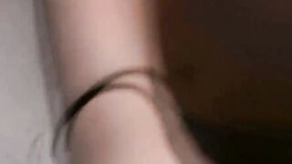 Dark Haired cutie jerking of a huge penis with titted