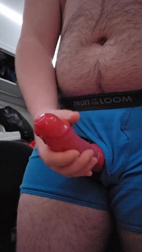 Chubby guy jerking off with condom through underwear hole