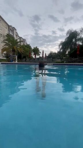 Carissa posing in the public resort pool