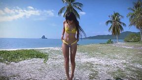 Beach babe flaunts micro bikini in seductive stroll