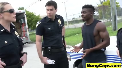 Two female cops take turns on a large black penis in a back of a truck