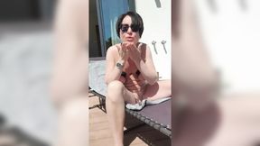 Milf Julie sunbathes naked in front of neighbors