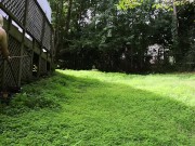 Big fake tits halter top Daisy Dukes wearing crossdresser cutting the grass