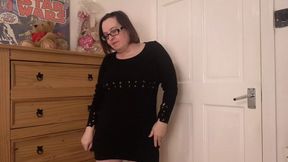 Sexy striptease in dark wool mini dress