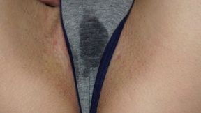 Wet panties betray her arousal as she touches herself