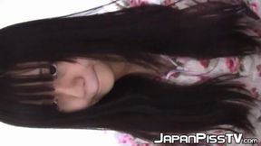 Japanese girl toys with her cat post-pee session