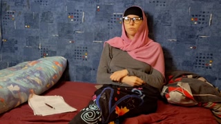 A Muslim student comes home from class and touches her teacher