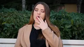 Sweet Russian girl smoke cigarette on the bench