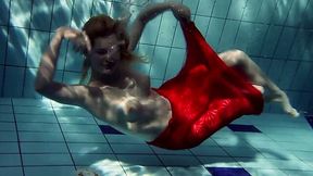 Blonde busty European teenie in red dress underwater