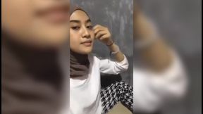 Beautiful girl who is squeezing her breasts alone