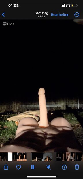 Riding a torso dildo at night in a parking lot