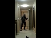 wearing wetsuit and fins shoot a quick load at open hotel door