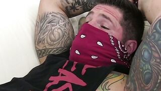 Bound inked hunk with mouth fold receives feet licking